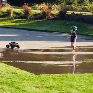 Kid chasing a Stampede truck in the water